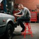 Heavy-duty aluminum garage bar chair in red with a 360° swiveling seat, ideal for workshop use and 41"-44" workbenches.