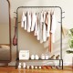 Heavy duty black metal garment rack showcasing hanging clothes and stylish tree branch patterns for a modern look.