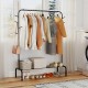 Heavy duty black metal garment rack featuring a stylish design with hanging clothing and shoes on the bottom shelf for.