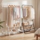 Heavy duty black clothes rack with hanging rod and two storage shelves for organizing clothing and accessories.
