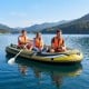 Heavy-duty inflatable boat for four, featuring buoyant design, PVC material, and rod holders for fishing trips.