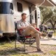Heavy-duty outdoor camping chair in red with cup holder and side pocket, perfect for relaxation at the campsite.