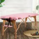 Height adjustable pink facial spa bed with a foldable design, reinforced beech frame, ideal for massage and spa use.