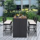 5-piece patio dining set featuring acacia wood table and PE wicker bar stools with soft cushions for outdoor comfort.