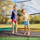 Two children jumping on a high-elastic PP replacement jumping mat for a 15 ft trampoline, perfect for outdoor fun.