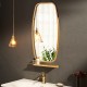 Modern wall mirror with bamboo frame and adjustable leather strap, perfect for bathroom or living room decor.