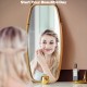 Elegant wall-mounted mirror with a bamboo frame and adjustable leather strap, providing a clear reflection for any.