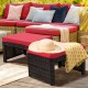 Red cushion patio rattan ottomans with X-frame design, suitable for outdoor use in garden or poolside settings.