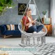 Hanging macrame hammock chair in gray with handwoven cotton backrest, perfect for indoor or outdoor relaxation.