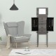 Standing jewelry cabinet organizer with wooden legs, featuring a mirror, five drawers, and side swing doors for.