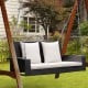 2-person patio rattan swing with white cushions, featuring sturdy steel chains for safe outdoor relaxation.