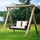 Rattan porch swing for two with white cushions, featuring sturdy steel chains for outdoor relaxation.