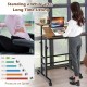 Mobile adjustable standing desk with walnut finish, tilting surface, and casters for easy movement in compact spaces.