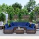 L-shaped patio rattan furniture set featuring navy cushions and a glass coffee table, ideal for backyard gatherings.