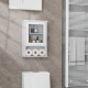 Wall-mounted white medicine cabinet with adjustable shelves, offering ample storage for bathroom essentials.