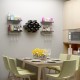 Wall mount wine rack set in black with shelves, storing eight bottles and displaying glasses, perfect for modern decor.