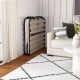 Twin size folding guest bed with memory foam mattress, compactly stored against the wall for easy access and.