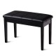 Black PU leather piano bench with solid wood construction, padded seat, and storage compartment for sheet music.