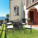 5-piece outdoor patio rattan dining set with glass top and cushions, perfect for family gatherings on the lawn.
