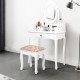 Vanity makeup dressing table in white with rotating mirror, cushioned stool, and three drawers for ample storage.