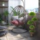 Decorative artificial cedar topiary tree with rattan trunk, featuring layered balls, ideal for indoor and outdoor decor.