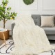 Cozy double-sided throw blanket featuring shaggy fur and smooth velvet, perfect for snuggling on a sofa or bed.