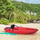 Red 6-foot youth kayak with folding backrest and paddle, perfect for kids over 5, set on a sandy beach.