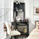 Corner computer desk with hutch in black, featuring ample storage shelves and a spacious desktop for efficient.