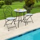 Two patio folding bistro chairs with blue floral mosaic pattern and a round table, perfect for poolside relaxation.