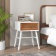 Mid-century modern rattan nightstand with white finish, spacious tabletop, and pull-out drawer for stylish storage.