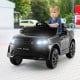 Kids ride-on Land Rover car in black with LED lights, remote control, and lockable doors for safe driving fun.