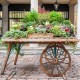 Decorative wooden wagon wheel with natural wood grain, perfect for garden or rustic decor, showcasing vintage charm.