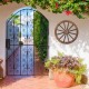 Decorative 30-inch wooden wagon wheel with natural wood grain, ideal for enhancing garden or outdoor spaces.
