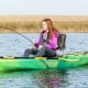 Padded camouflage boat seat with ergonomic backrest, ideal for fishing and outdoor adventures, shown in use on a kayak.