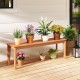 Teak wood outdoor bench with potted plants, featuring a solid construction and 880 lbs weight capacity for patio use.