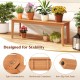 Teak wood bench with reinforced crossbars, designed for stability, perfect for outdoor patio seating.