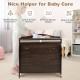 Baby changing table in brown with three drawers, safety belt, and sturdy construction for convenient diaper changes.