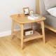 Boho bamboo side table with faux rattan shelf, featuring a natural finish and elegant curved design for stylish storage.