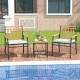 Two ergonomic outdoor chairs with white cushions and acacia wood accents, paired with a small table for patio.