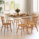 Extendable dining table with rubber wood legs, set for 8, featuring oak wood veneer and elegant turned legs.
