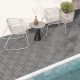 Gray interlocking deck tiles arranged on a patio, showcasing a slatted design for outdoor elegance and drainage.