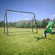 Kids soccer player kicking a ball towards the adjustable 2-in-1 soccer goal and rebounder on a grassy field.