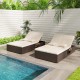 Patio double chaise lounge with beige cushions, adjustable backrests, and folding side trays, perfect for poolside.