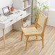 Rattan dining chair with natural cane backrest and teak wood frame, perfect for stylish home office or dining spaces.