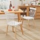 Windsor dining chairs with spindle backs and curved seats in white, featuring a sturdy beech wood frame for comfort.