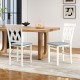 White folding wooden dining chairs with faux leather upholstery, ideal for small spaces and comfortable seating.