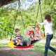 Colorful 60-inch saucer swing with LED lights, holding multiple kids, perfect for outdoor fun and nighttime play.