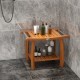 Teak wood shower bench with curved seat and handles, featuring a double-layer shelf for storage in a modern bathroom.