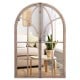 Arched window pane mirror featuring a rustic wooden frame, adds elegance and brightness to any living space or hallway.
