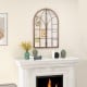 Arched window pane mirror with rustic wooden frame, ideal for living rooms and entryways, enhancing charm and.